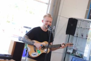 Sam singing and playing guitar