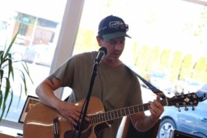 Dennis playing guitar and singing