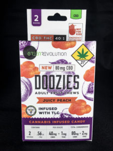 package of CBD juicy peach Doozies by Green Revolution with black background
