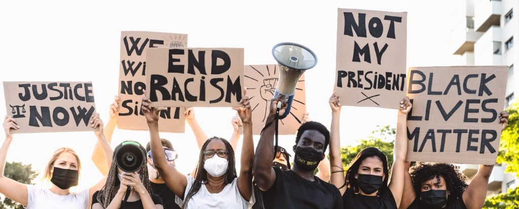 Activist movement protesting against racism and fighting for equality - Demonstrators from different cultures and race protest on street for equal rights - Black lives matter protests city concept